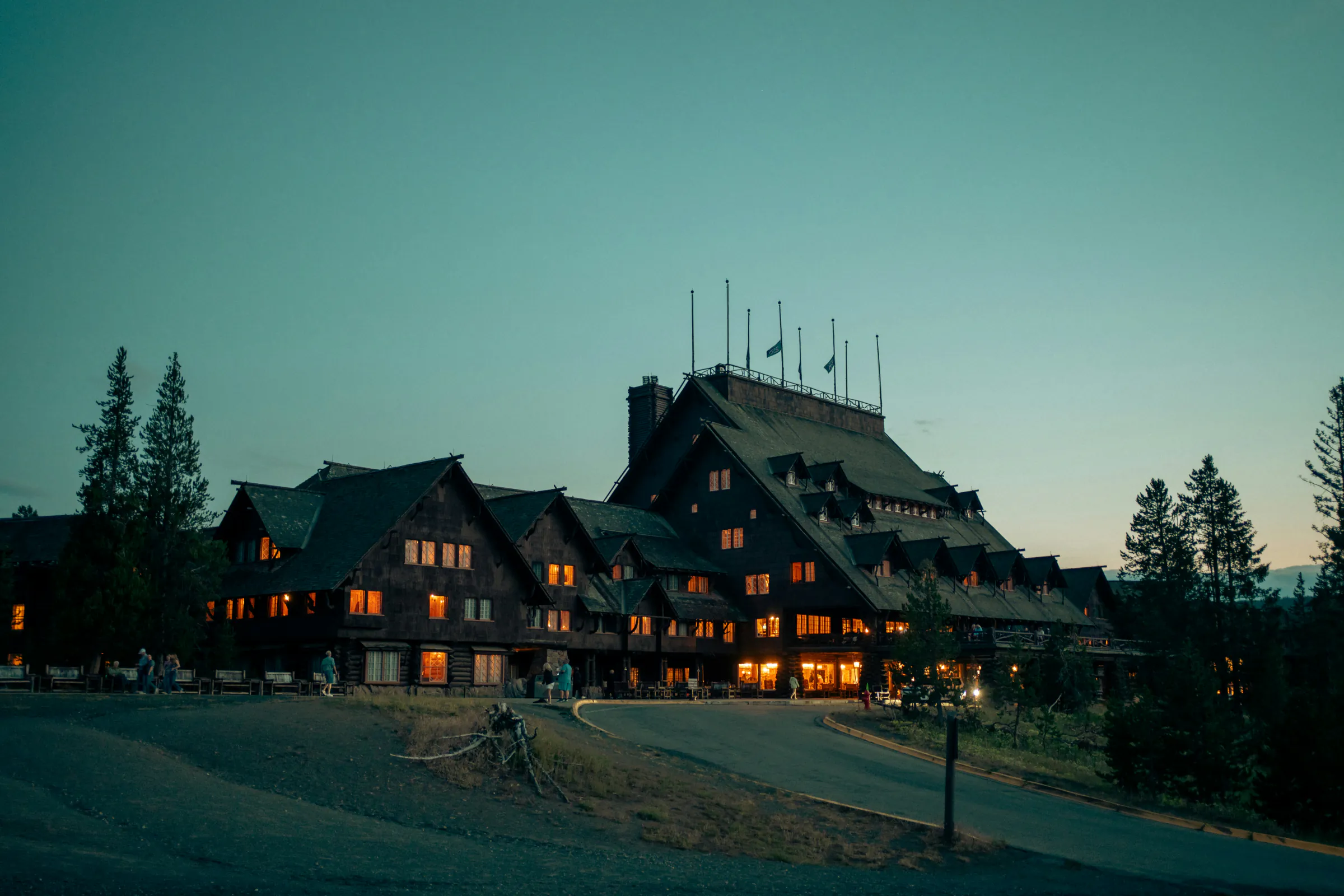 The house at dusk, its windows lit, as it stands now